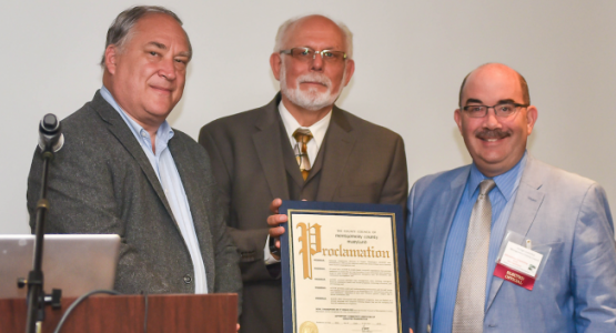 Montgomery County Council members Mark Elrich (left) and George Leventhal (right) present a proclamation of congratulations for ACSGW’s 35 years of service to Ken Flemmer, executive director. Montgomery County Council members Mark Elrich (left) and George Leventhal (right) present a proclamation of congratulations for ACSGW’s 35 years of service to Ken Flemmer, executive director.