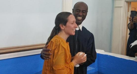 Enock Bouzy, lay pastor of the Collingwood Park church, baptizes a woman during the fall evangelism initiative. Enock Bouzy, lay pastor of the Collingwood Park church, baptizes a woman during the fall evangelism initiative.