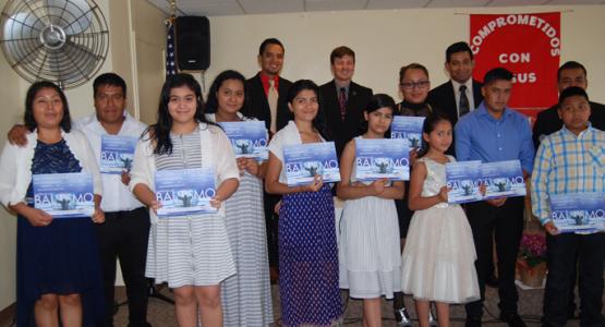 New members (front row) display their baptismal certificates. New members (front row) display their baptismal certificates.