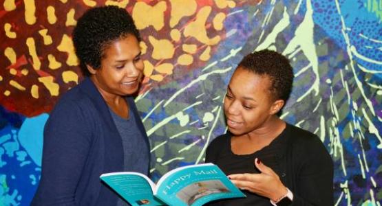 Math teacher D’Anya Brezzell (right) shares her thoughts about Kelli Raí Collins’ new devotional book. Math teacher D’Anya Brezzell (right) shares her thoughts about Kelli Raí Collins’ new devotional book.