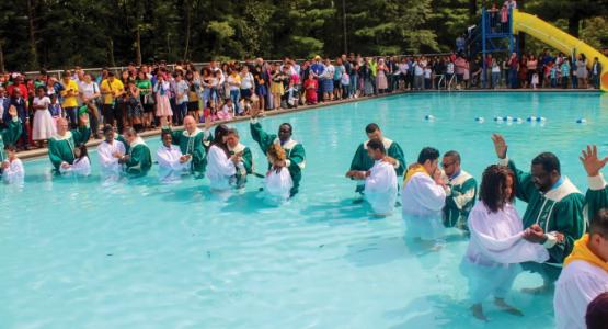 Sixty-four people, Hispanic and non-Hispanic, celebrate baptism during the Hispanic Camp Meeting Sixty-four people, Hispanic and non-Hispanic, celebrate baptism during the Hispanic Camp Meeting