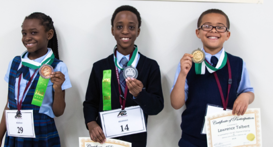 Science Fair primary winners llide Iheme, third place (BJA); Daniel Lightbody, second place (W. F. Mays); and Lawrence Talbert, first place (Dupont) display their medals. Science Fair primary winners llide Iheme, third place (BJA); Daniel Lightbody, second place (W. F. Mays); and Lawrence Talbert, first place (Dupont) display their medals.
