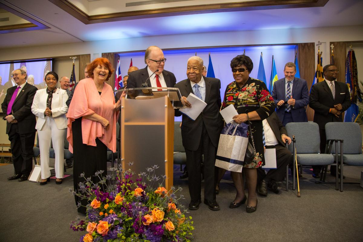 Daniel R. Jackson, NAD president, and wife Donna Jackson, present Charles E. Bradford, first and former NAD president, and wife Ethel Bradford with gifts during the NAD headquarters' dedication program on Oct. 26, 2017. Photo by Pieter Damsteegt