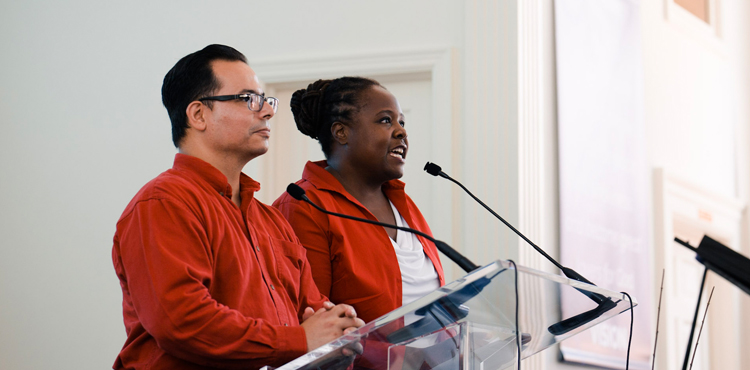 Jose Cortes Jr, an associate ministerial director of the North American Division, and Celeste Ryan Blyden, a vice president at the Columbia Union Conference, lead worshippers in a prayer of commitment during the August 19 joint worship service in Charlottesville, Va. 
