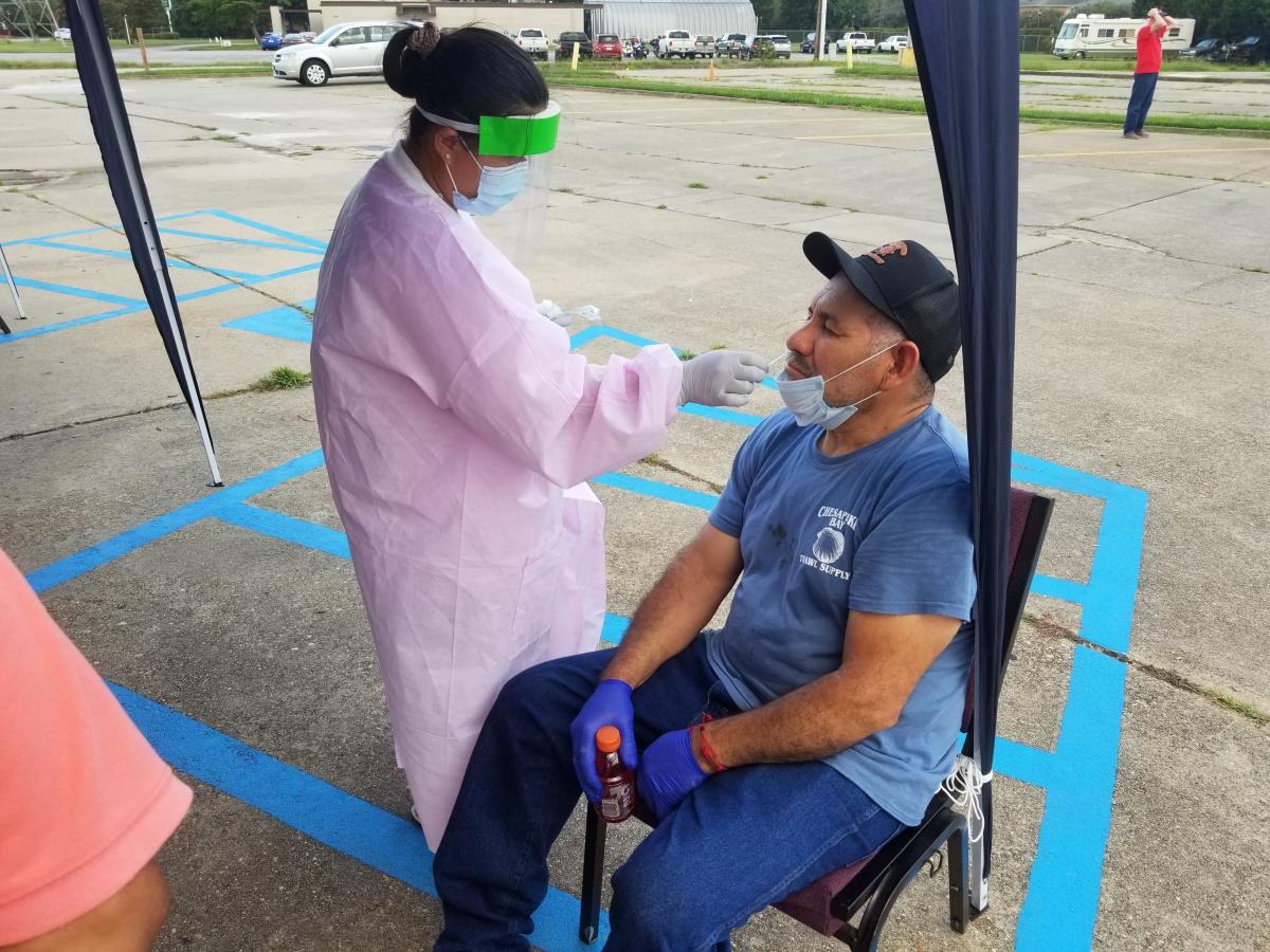 Peninsula Spanish member Domingo Flores takes advantage of the free COVID-19 test during the food bank event, administered by a local agency worker.