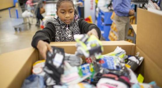 A young WGTS listener dropping off her socks for the homeless. A young WGTS listener dropping off her socks for the homeless.