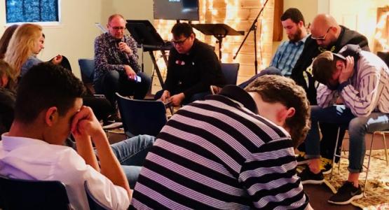 Edward Marton, Ohio Conference’s Youth Ministries director, leads prayer with high school students and youth pastors during the “ReCharge” event at the Worthington church. Edward Marton, Ohio Conference’s Youth Ministries director, leads prayer with high school students and youth pastors during the “ReCharge” event at the Worthington church.